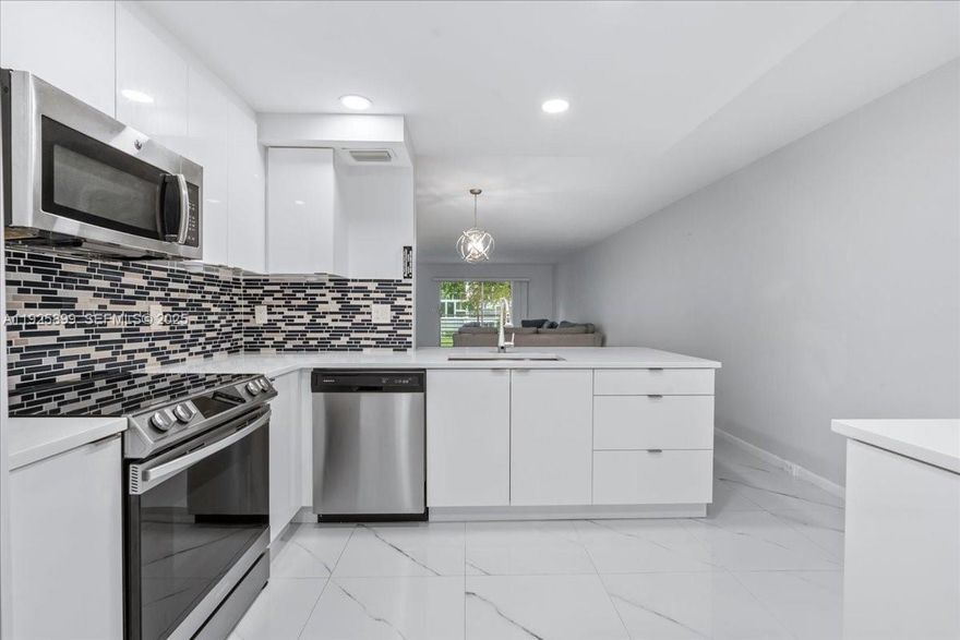 This move-in ready 2-bedroom, 2-bath home offers a modern open kitchen with white cabinets, quartz countertops, and stainless steel appliances, elegant porcelain floors, and updated bathrooms. Relax on your private terrace with serene garden and pool views in this gated 55+ community requiring 20% down & at least one occupant 55+. Wynmoor Village features resort-style amenities including golf, tennis, fitness, theater, pools, bistro café, and a lively social calendar. Ideally located in Coconut Creek, the “Butterfly Capital of the World,” near shopping, dining, parks, and the new MainStreet development with shops, restaurants, and recreation. Don’t miss this one!