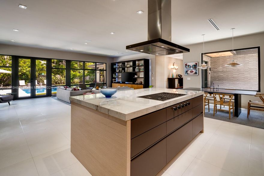 Understated elegance nestled on a 12,750 foot private, lushly landscaped lot! This beautiful gem was recently renovated to very high standards. Gorgeous limestone floors in the expansive social areas, rift white oak wall paneling and flooring warming the entry and bedroom spaces. Wolfe, Sub-Zero and Miele outfit the custom kitchen, open to an inviting great room; beyond, through walls of glass, a glistening pool surrounded by a lovely patio and entertainment space. The private backyard has plenty of room for children or adults to play. Alice Wainright Park is one block behind, with the most glorious sunrises awaiting your arrival. Fabulous location near the entrance to Key Biscayne, the Brickell and Coral Gables business districts, vibrant Coconut Grove and all that our paradise offers.