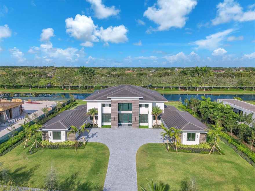 Welcome to this Luxurious Grand Villa situated in the heart of Weston,FL at Windmill Reserve. This stunning New Construction home showcases premium & imported finishes with high-end architectural and design features including a breathtaking fireplace, top-of-the-line appliances,vanities, floating stairs, marble patio with serene water features & lake views. This modern 12,114 sq ft home offers an open and airy ambiance with impressive vaulted ceilings. Enjoy state-of-art media/theater room, wet bar, resort style pool, salon, fitness room, & Large en-suite bedrooms with walk-in closets & more. This is a true masterpiece and stands out as the best new luxury home available in Weston today.