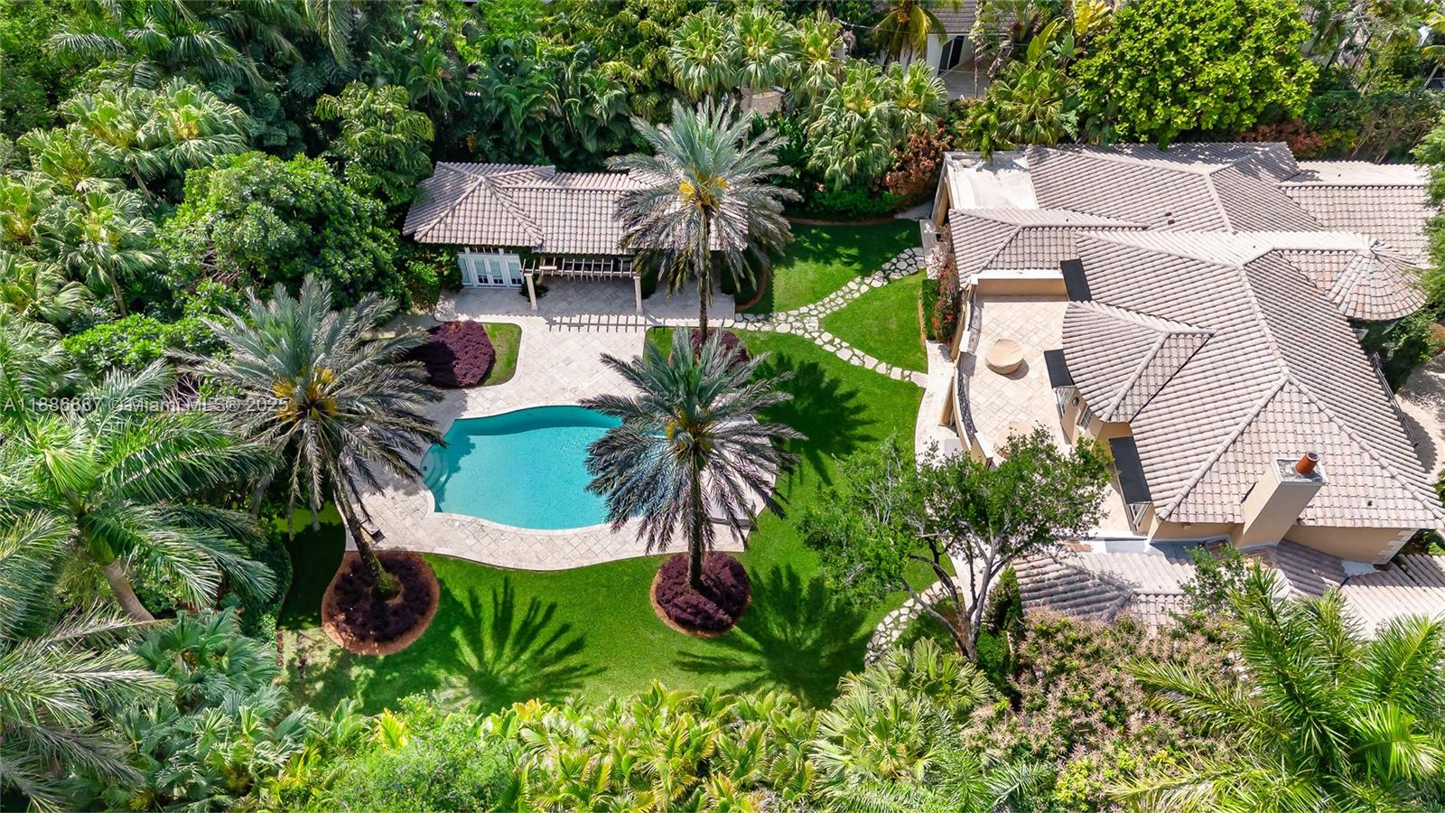 Located in the heart of Ponce Davis, this timeless, wrapped in fully grown ivy estate nestled on a cul-de-sac behind private gates, offers 6 bedrooms, 6.5 bathrooms, service quarters, a fully equipped guest house, and a 3-car garage. The residence sits on a 42,253 sq. ft. lot surrounded by lush landscaping. On the first floor, the primary bedroom includes a large private den, ideal as an additional workspace. Upstairs, three ensuite bedrooms each open to an oversized balcony overlooking the private backyard, which features an outdoor kitchen, bar, dining area, and ample poolside lounging space embraced by oak trees.