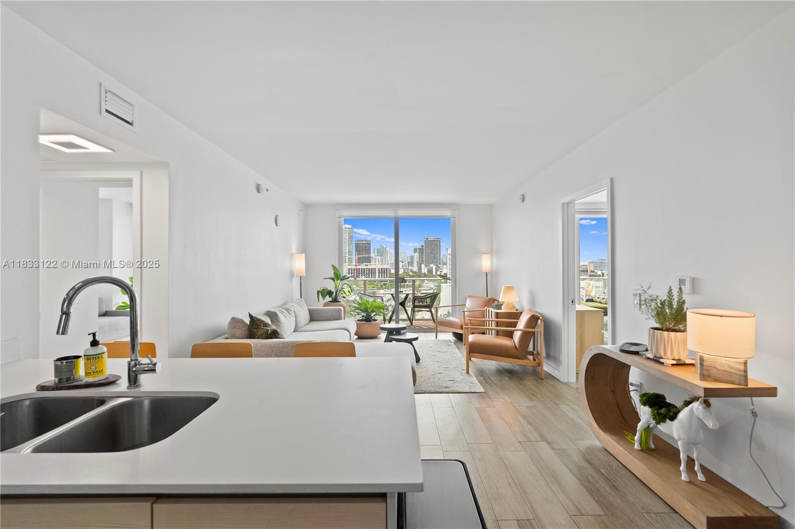 Breathtaking bay and skyline views in a modern luxury building near Miami’s Design District. This high-floor 2BD + den, 2BA is the best-priced unit in the coveted 18 line, with expansive southern exposure and floor-to-ceiling windows. Enjoy indoor-outdoor living with a large balcony overlooking Biscayne Bay and downtown. Features include porcelain tile throughout (including balcony), modern kitchen with stainless steel appliances, updated bathrooms, custom blackout shades, and in-unit washer/dryer. The den is ideal as an office or guest space. Baltus House offers resort-style amenities: rooftop jacuzzi deck, heated bayview pool, gym, lounge, and 24-hr concierge. Minutes from Wynwood, Midtown & Miami Beach.