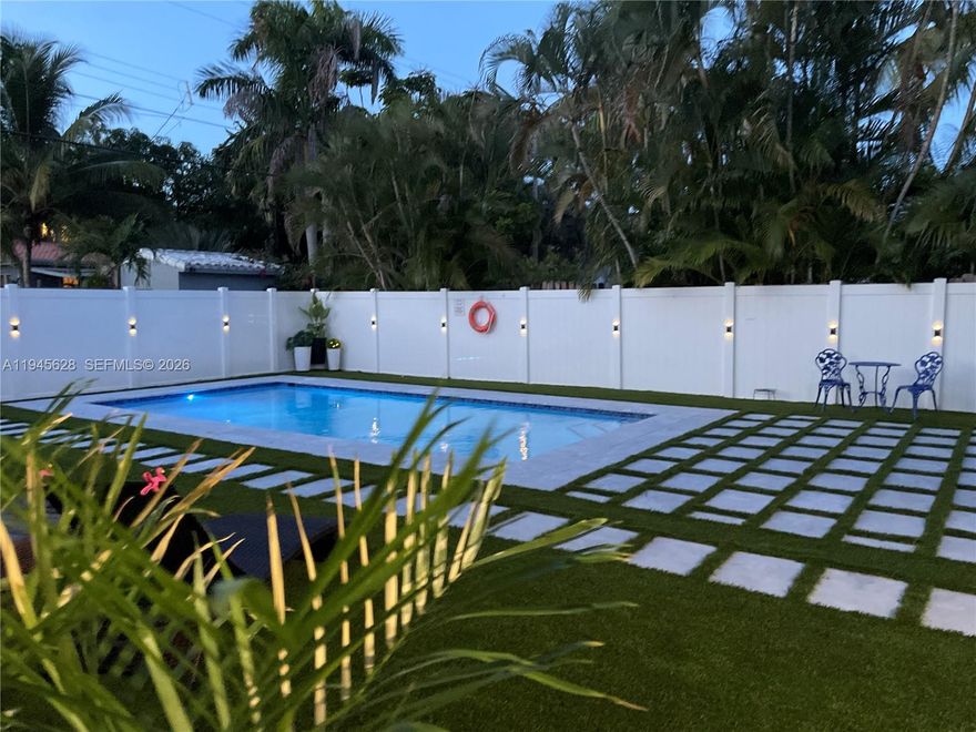 Welcome to this beautiful pool home where modern elegance meets everyday comfort. Step inside to discover a gorgeous kitchen with stainless steel appliances, spacious living areas with newer flooring and large windows that fill the space with natural light. Both bathrooms have been beautifully updated with stylish finishes. Outside, your private oasis awaits! A heated saltwater pool surrounded by a huge backyard fully fenced with white PVC and a covered barbecue area make perfect combination for entertaining or unwinding. With hurricane-proof windows and doors and two A/C units, this home offers comfort and peace of mind year-round. Located in a quiet neighborhood just steps from a public tennis court and minutes from the beach and local restaurants!