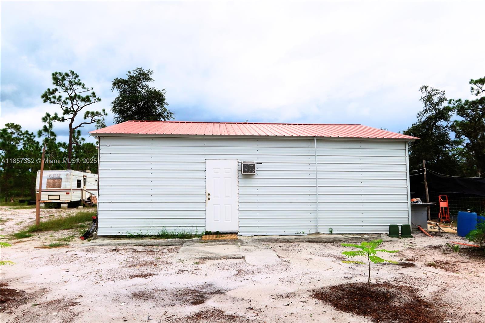 Rare Opportunity in Venus, FL! Discover 3.5 acres of fully fenced, improved land ready for your vision. This unique property includes a metal building used as a residence, complete with electric connections, septic tank, and completed permits—perfect for immediate occupancy or future development. Enjoy the peaceful country lifestyle with a private pond, animal pens, and mature fruit trees including mango, lemon, and pineapple. With infrastructure in place and plenty of room to grow, this is an ideal setup for homesteaders, hobby farmers, or anyone seeking space and self-sufficiency. Don't miss out on this versatile, ready-to-go property in a quiet and desirable location!