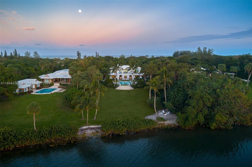 Ocean-to-Intracoastal estate spanning ±4.15 acres. This 10,315 SF British Colonial masterpiece offers 5 bedrooms, 6.5 bathrooms, and a 4-car garage.
The gourmet kitchen flows into an exquisite blue lacquer bar and formal dining area, enhanced by a temperature-controlled wine room. From the private gym to the serene office with its cozy terrace and fireplace, every detail exudes luxury. Expansive waterfront loggias offer breathtaking views of the Intracoastal, perfect for relaxation or entertaining.
A 4,576 SF guest house complements the main residence, with 3 bedrooms, 3.1 bathrooms, and a 2-car garage with the option for two more spaces.
With ±131 feet of ocean and 135 feet of Intracoastal frontage and a newly approved dock with a boat lift, this estate is a boating enthusiast's dream.