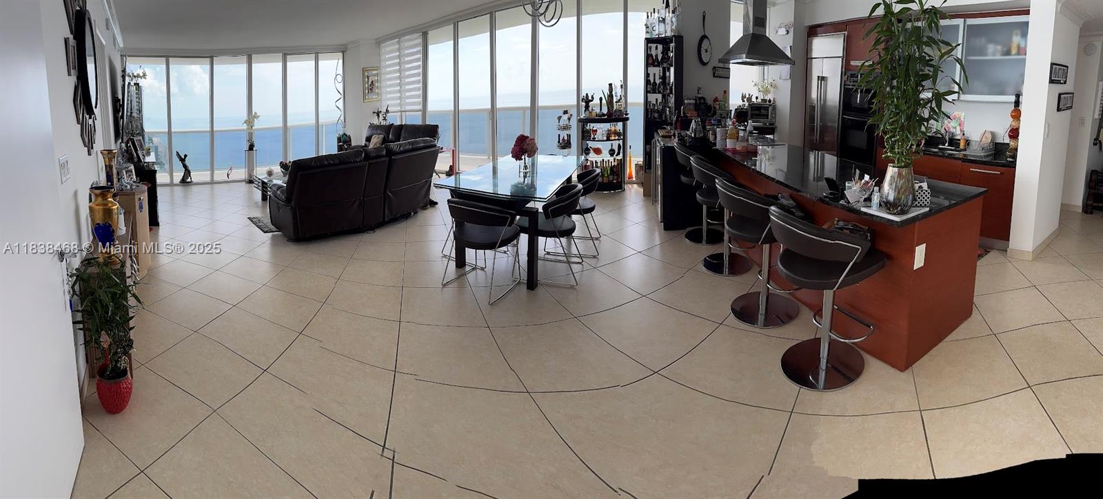 Experience luxury oceanfront living in this fully renovated high-rise apartment with breathtaking panoramic views. Floor-to-ceiling windows surround the open-concept living space, filling the home with natural light and endless ocean vistas. The expansive wrap-around balcony is perfect for entertaining or relaxing, while the spa-inspired primary bath features a Jacuzzi tub and sleek indoor shower. Modern finishes, a gourmet kitchen, and seamless indoor-outdoor flow create an elevated yet comfortable atmosphere. Enjoy resort-style amenities including 24-hour security and valet, five heated pools, an oceanfront spa, fully equipped fitness center, and private beach access. This is coastal living at its finest—where every day feels like a vacation.