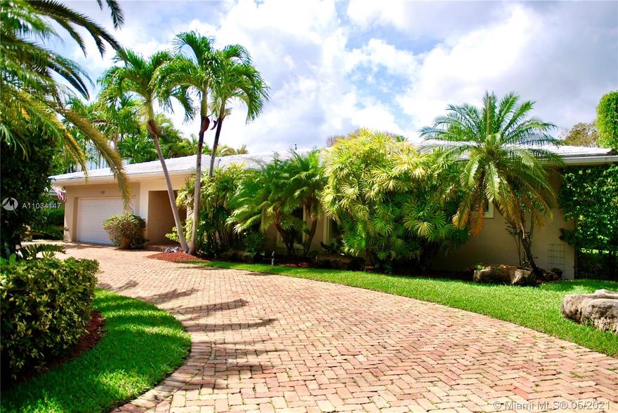 Your New Home in beautiful Coral Gables Awaits you! This bright, open and spacious floor plan boasts 4 large bedrooms, 3 full baths in a split plan with private master suite. Bamboo wood floors throughout. Lots of closets. custom built wooden kitchen cabinets with frosted glass doors, granite countertops, stainless steel appliances including wine cooler,  touch-less sensor faucet. Pass-through window with ledge to host your family and guests in the patio. Formal living room and dining area. Slidding glass doors in master bedroom, formal dining and lounge/media room leading to backyard and Pool with beautiful color lighting. Circular driveway with lush landscaping. 2 Car Garage semi converted into useful space with extra 1/2 bathroom, washer and dryer.