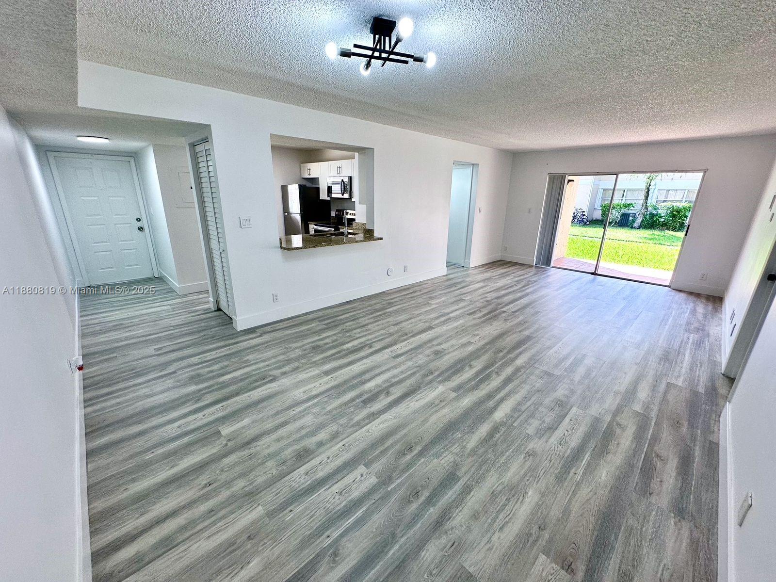 Spectacular fully renovated first floor corner unit with 2 bedrooms and 2 full baths with a beautiful garden view. Unit includes 2 parking spaces. New flooring throughout unit. Open split floorplan with washer/dryer. Great for your first starter home in Coral Springs with central location close to shopping and highways. Must see, don't miss this opportunity to own this amazing place!!!