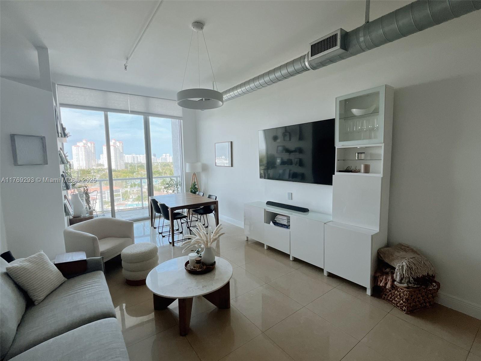 This luxurious NY-style loft at a prime location features three spacious bedrooms and two full bathrooms, with a 12-foot ceiling and is freshly renovated. You'll be able to enjoy stunning views of the intercoastal water and the resort-style pool. The open-concept living area is great for entertaining, and the kitchen boasts modern appliances and ample storage space. You'll also have the convenience of in-unit laundry and TWO private balconies. The unit includes two personal parking spaces. The community provides numerous amenities, including a state-of-the-art fitness center, sauna, jacuzzi, swimming pool, party room, business center, basketball, and tennis courts. With 24-hour security and valet parking.