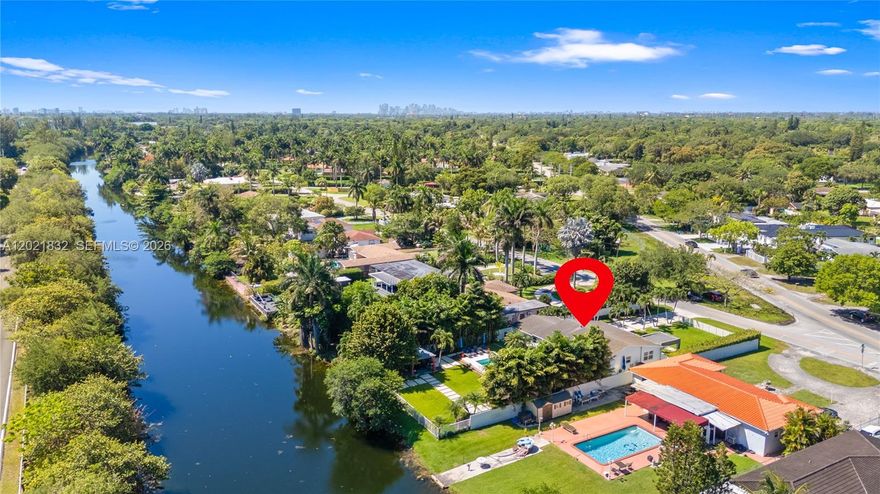 Experience a serene waterfront retreat where modern luxury meets Miami living. Set along the Biscayne Canal with access to the north lake and Biscayne park to the south for watersports fun, this fully gutted and rebuilt 3BD/2BA contemporary home offers 1,640 SF of refined comfort on a lush, fenced lot with an electric front gate. Inside, porcelain floors flow through an open layout with a sleek modern kitchen, updated bedrooms and baths, and a third bedroom with private access. Outdoors, enjoy a tranquil oasis with a new heated pool and jacuzzi, covered patio, gazebo, summer kitchen, solar-powered LED lighting, and beautiful water views from the patio and primary suite. With impact windows, security system, a newer 2020 roof, brand new plumbing and electrical installation, no HOA, and turnkey appeal, this rare waterfront property delivers privacy, elegance, and effortless indoor-outdoor living. Schedule your private tour today, and you will fall in love to it.