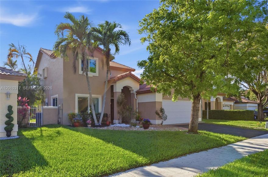 Location! Location! Location! Beautiful home that blends refined elegance with comfort. Nestled on a quiet cul-de-sac in the gated Cypress Lakes community, this fully remodeled home features 3 bedrooms, 2.5 baths, a 2-car garage, and a versatile first-floor room that can be a 4th bedroom. Two story high ceilings and marble floors highlight the open-concept layout. The kitchen features an island, granite countertops, SS appliances, and a double oven. The first-floor primary suite includes a walk-in closet and spa-like bath with a cast iron soaking tub and rock-accent wall. The private backyard has a playground, delicious mango/avocado trees, and room for a pool. Impact windows/doors, hurricane protection, and security cameras included.  Low HOA includes front lawn maintenance.