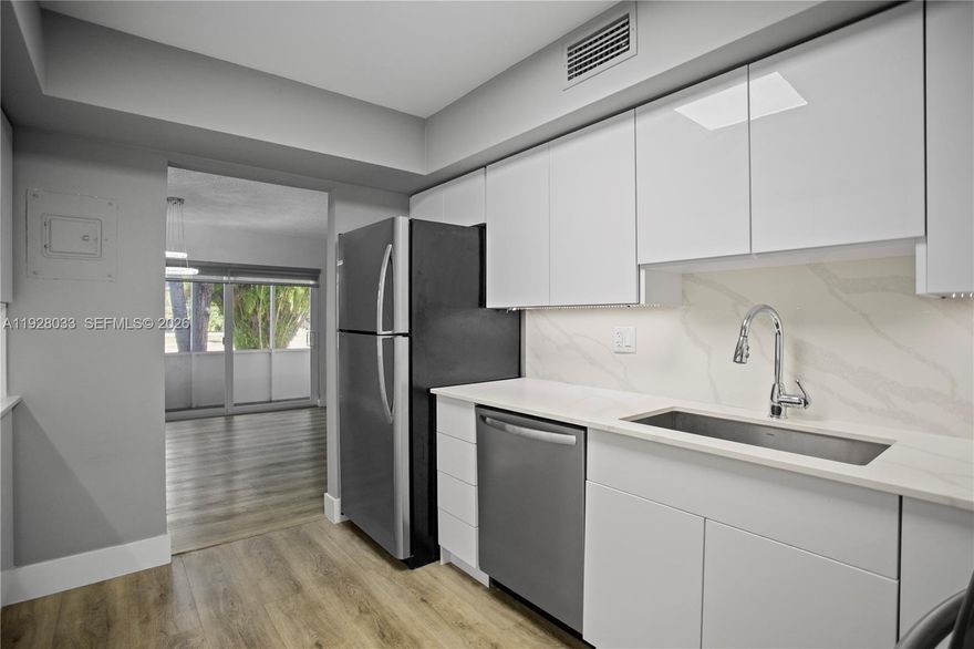 Remodeled first-floor condo in a beautiful All-Ages community featuring impact windows throughout. This spacious unit offers a modern and large kitchen with abundant high-end cabinetry, sleek quartz countertops, and new appliances. Both bathrooms have been tastefully upgraded with designer finishes, tankless toilets, and modern lighting. Additional highlights include Hunter Douglas window treatments, updated plumbing, and upgraded electrical throughout. The community is thoughtfully designed in a square layout and uniquely bordered by two canals, providing privacy, scenic water views, mature trees, and a variety of birds—creating a peaceful, nature-inspired setting. Ideally positioned, you’ll enjoy close access to the sports center, beautiful pool, clubhouse, basketball, soccer, tennis courts, barbecue areas, and scenic walking paths. With Cypress Creek just behind the neighborhood, it’s a welcoming blend of nature and convenience.  The location is exceptional—directly across from The Lakeside Shopping Plaza with Walmart, Marshalls, and popular restaurants, minutes to the Turnpike, 441, hospitals, and only 12 minutes to the Pompano Beach Pier for oceanfront dining, hotels, and entertainment. FHA and VA Approved. Purchase with as little as 3% down. The community has reserves and strong insurance. COA requires 3 months escrow upon approval. DTI below 40% and minimum credit score 650.  No special assessments. Newly paved parking is coming soon.Worry-free condo unit!