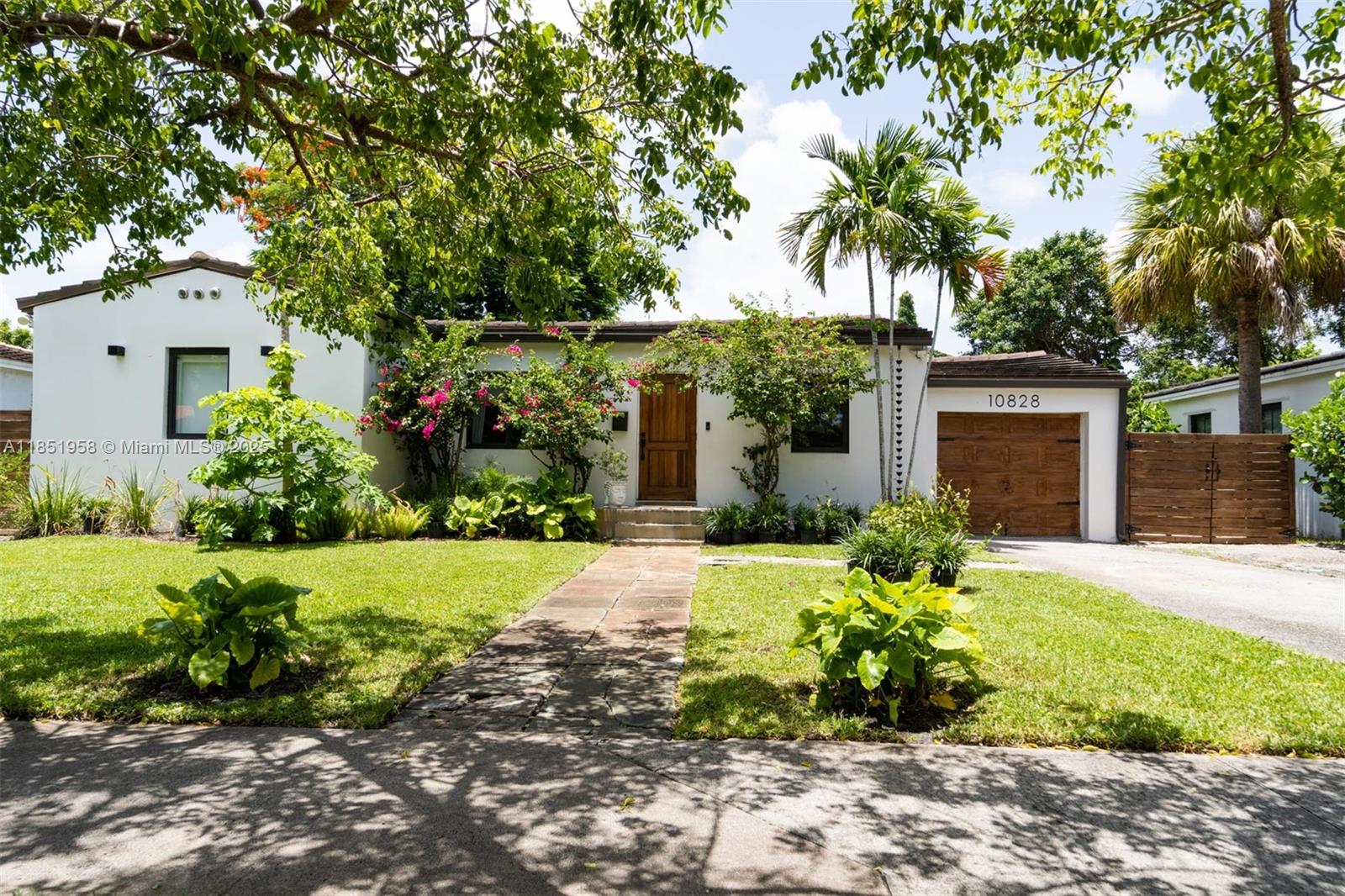 Welcome to this peaceful, Zen-inspired tropical home, nestled on an expansive 8,750 sq ft lot with lush landscaping and a garden ready for your own farm-to-table lifestyle. The garden is enhanced with fruit-bearing papaya, loquat, banana, and mulberry trees, creating your own private tropical orchard and a true connection to nature.
The roof was replaced in 2019, new insulation was recently installed, impact windows and doors, motorized blackouts and blinds and the A/C unit is from 2020. Inside, you’ll find updated bathrooms, a stylish new pergola, and plenty of natural light throughout. The one-car garage adds convenience, and the oversized lot offers endless potential for outdoor living or expansion.