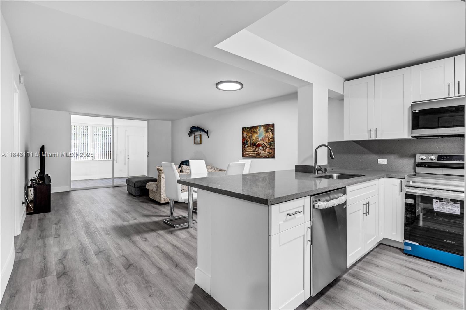 FULLY REMODELED UNIT WITH BRAND NEW APPLIANCES, UPDATED BATHROOMS, VINYL FLOORING LARGE MASTER BEDROOM WITH SUN ROOM . WASHER DRYER ON EACH FLOOR WITH ADDITIONAL SEPARATE STORAGE AREA CONVENIENTLY LOCATED MIAMI DADE AND BROWARD COUNTY CLOSE TO AIRPORTS, PORT, BEACHES, ENTERTAIMENT, HARD ROCK STADIUM. NO RENTING FOR THE 1 ST 2 YEARS. HAS A SPECIAL ASSESSMENT FOR $105.00.