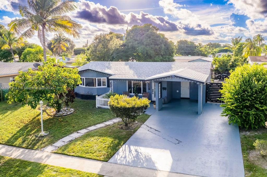 Nestled on a beautiful tree-lined street, this elegant single-family home offers the perfect blend of style, comfort, & location. Just minutes from the beaches, airports, Downtown Fort Lauderdale, & the Sawgrass Mills Mall. The home features a 4-car driveway & a covered carport. The front yard is beautifully landscaped with palm trees, while the soffits are enhanced with dimmable LED lighting. Major updates include a new roof & a new AC system, Vinyl wood flooring throughout, freshly painted interiors, & a bright, open floor plan. The modern kitchen has quartz countertops, stylish cabinetry that complements the flooring, & appliances for a sleek & functional cooking space. The backyard has a mature fruit tree. The paved area offers ample room for a BBQ grill & outdoor entertaining.