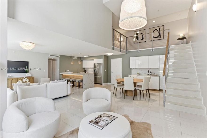 Rarely available, best priced, one-of-a-kind bi-level townhome that lives like a single-family home while offering the comfort & enjoyment of condo amenities—only 5 similar units in the building. Nearly 2,000 SF of interior space plus a 400+ SF expansive private terrace, perfect for relaxing or entertaining. The main level flows seamlessly outdoors, creating exceptional indoor-outdoor living with one bedroom and bathroom. Enjoy soaring 18-ft ceilings, floor-to-ceiling windows, and abundant natural light. Sleek upgraded kitchen with deep island, extra cabinetry, and newer appliances. Includes 2 parking spaces. Located in the heart of vibrant Brickell, literally steps to world class dining, shopping, and nightlife. Axis offers resort-style pools, steam room, state-of-the-art gym, kids’ playroom, and easy access to transit and Brickell City Centre.