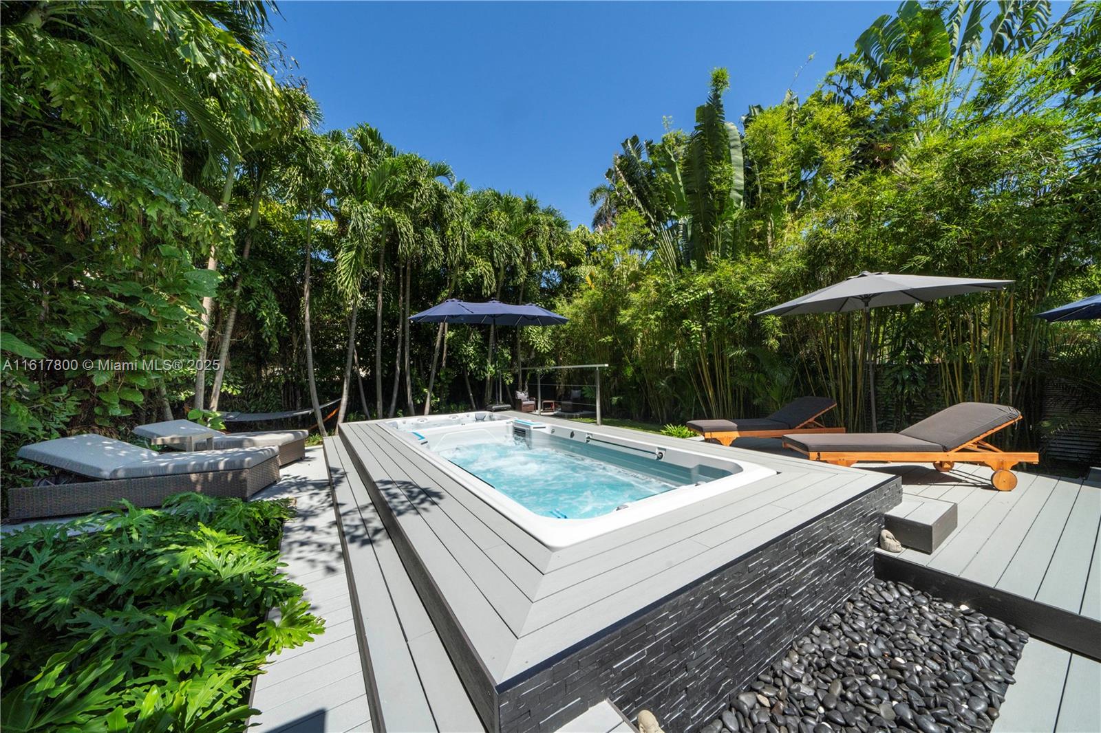 Welcome to this serene beach bungalow in the heart of Miami Beach! Nestled on a gated & spacious 7,500 SF lot, surrounded by lush tropical landscaping. Inside find chic interiors, high ceilings, an open eat-in kitchen, impact windows & floor-to-ceiling glass, spacious bedrooms, & primary suite w/ walk-in closet & bath w/ dual sinks, bidet system, & rain shower w/ massage jets. Entertain in style in the gorgeous & private backyard w/ multiple lounging areas, new summer kitchen, Al Fresco dining, & Endless Pool Swim Spa! Ample upgrades including: newer roof (2019), newer A/C, new tankless water heater, new washer/dryer, new lighting throughout, & new custom electric blackout blinds. Location, Location, Location! Live on a quiet tree-lined street only 1 block away from Lincoln Rd & SOBE!