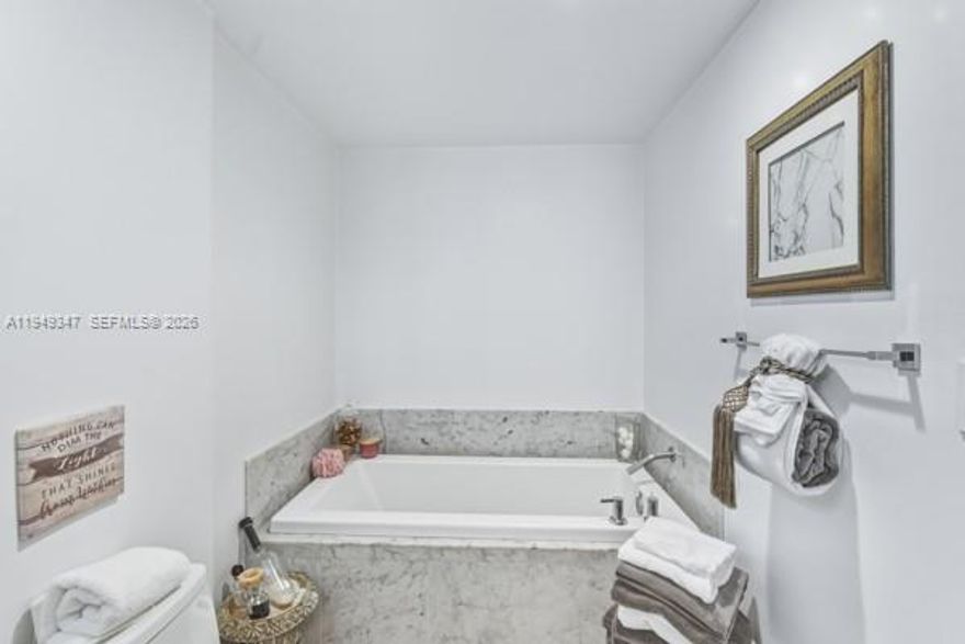 Live in the heart of Downtown Miami at Viscayne South.  This beautiful one bedroom, one bath residence on the 10th floor offers views of Biscayne Bay, complemented by serene pool views that create a true sense of coastal living.  Floor to ceiling impact widows flood the space with natural light while warm wood floors add comfort and style throughout.  The open kitchen features modern cabinets and stainless steel appliances, seamlessly connecting to the living area, perfect for relaxing or entertaining while enjoying the bay views.  Viscayne South offers resort style living with two sparkling pools, a luxury spa, fully equipped fitness center, sauna and steam room, club room, billiard room, business center, and a 24hrs concierge service,