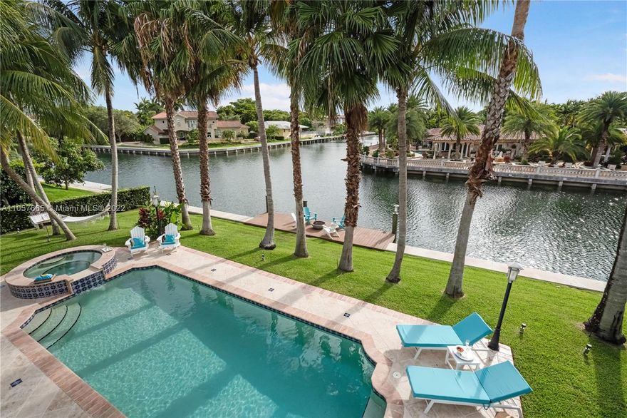 Say hello to your dream waterfront home resort-style living in Gables by the Sea, a tranquil guard-gated community. Live amid beauty and serenity in a spectacular 2-story, 4,056 SF remodeled for luxury living. Newly upgraded with a $500K renovation to the highest standards, w/high ceilings, Porcelanosa floors, impact windows and doors throughout, brand new kitchen, roof and driveway. Take in the gorgeous sunsets over the water, either from the hammocks swinging between the palm trees or while indulging in the Jacuzzi cascading into the pool. Prepare meals in the beautiful, open-plan kitchen complete with a giant natural quartzite island and Sub-Zero/Wolf appliances. Wake up to a breakfast in the master suite’s waterfront balcony overlooking a gorgeous patio and lush tropical surroundings.