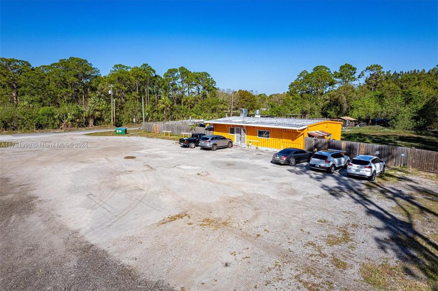 This property offers 1.15 acres of general commercial land with ample space to construct additional buildings. The existing 1960 sq. ft. restaurant, featuring a full kitchen, bar, and large freezer, can be easily transformed to fit various business needs. It is an ideal location for a convenience store, farmers market, gas station, or storage facility. The area is in demand for a farmers market, especially with ongoing residential developments and the upcoming expansion of Orange Avenue. The property includes an industrial water system.