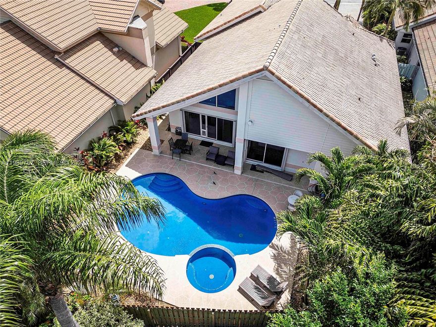 New price in Ironhorse, a 24-hour guard-gated golf community known for its privacy, natural beauty, and strong sense of neighborhood. Set on a quiet cul-de-sac, this 3-bedroom, 2.5-bath CBS pool home offers 2,533 square feet of one-story living with vaulted ceilings, a double-sided fireplace, and a first-floor primary suite with a renovated bath and oversized walk-in closet. The kitchen features wood cabinetry, granite countertops, double wall ovens, and a built-in wine bar, ready for a buyer's refresh. A heated saltwater pool and spa with south exposure anchor the fenced backyard. 2-car garage. An opportunity to own in Ironhorse and bring the home to its full potential. The community borders the 20,000-acre Grassy Waters Preserve, and optional membership to The Preserve at Ironhorse Country Club includes a Rees Jones redesigned golf course, tennis, fitness, and clubhouse dining. Conveniently located near Palm Beach beaches, Palm Beach International Airport, I-95, and the Florida Turnpike. Sold as-is.