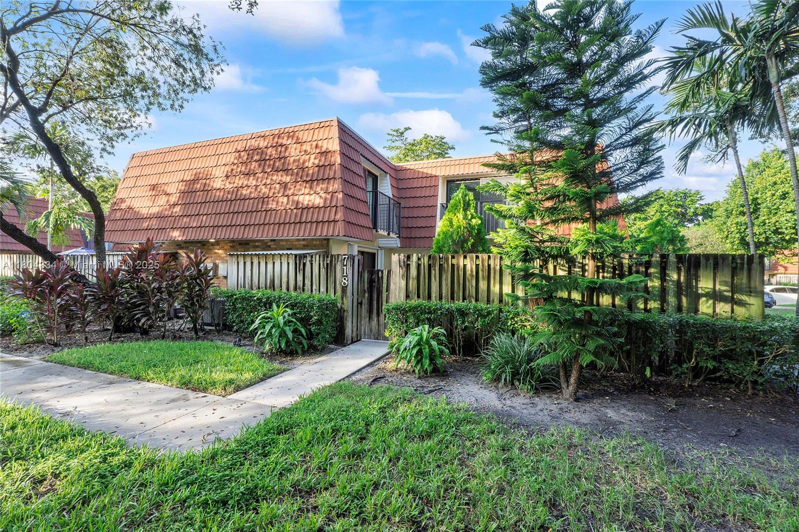 Charming 2-bedroom, 2.5-bath corner-unit townhouse with a private paved patio, ideal for relaxation. Located in Plantation, it features recent impact-rated sliders and accordion shutters enhance security. Updated kitchen with granite countertops, a spacious living area, and a mix of tile and vinyl flooring. Enjoy the convenience of an in-unit washer and dryer and beautifully upgraded bathrooms. The air conditioning is just two years old. The HOA maintains the roof, which is five years old. The property includes two assigned parking spaces, ample guest parking, and is pet-friendly with minimal leasing restrictions. Resident access to the pool and community events is also included. Just 5 minutes from Plantation Central Park, this move-in-ready home offers excellent amenities!