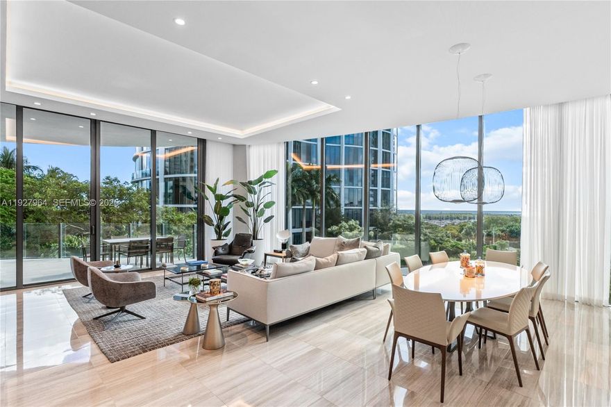 Sophisticated 4-bed + den residence at Park Grove T2 with 3,233 SF of refined living, 5.5 baths, soaring 12-ft ceilings and a spacious terrace overlooking Biscayne Bay, the pools and lush gardens. Designed by William Sofield, the home offers a beautifully appointed Poliform kitchen, spa-quality bathrooms, elegant marble floors, custom designer wallpaper, all en-suite bedrooms, his-and-her closets and premium Sub-Zero, Miele and Wolf appliances. Residents enjoy resort-style amenities including 24/7 concierge and butler service, private cabanas, multiple pools, a dining room, library, screening room, fitness center, yoga spaces and a wine cellar, plus a large laundry room and two parking spaces.