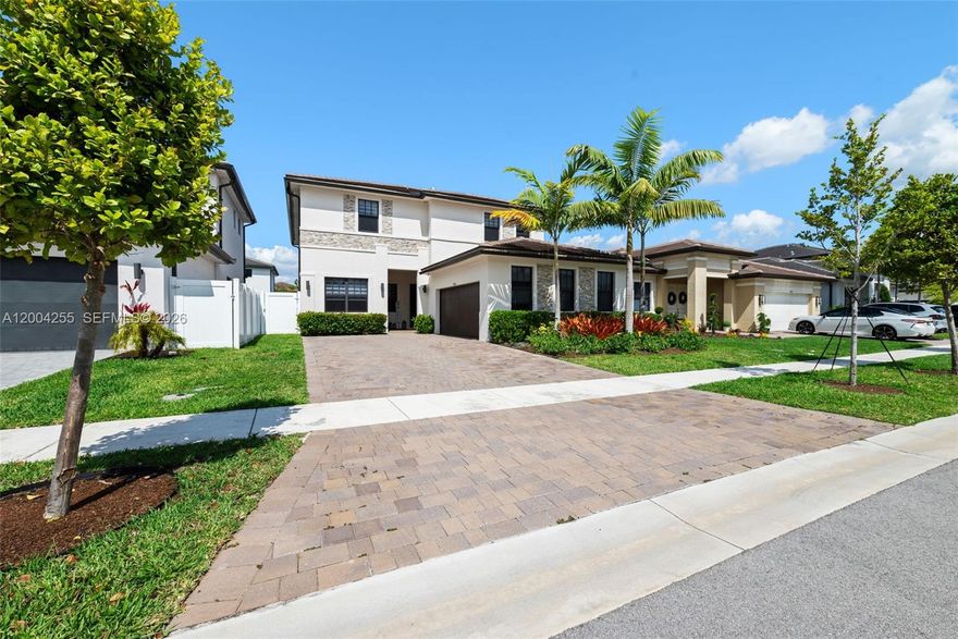 Located in the prestigious Marbella subdivision in Miramar, this exceptional residence offers a rare Next Gen layout with a private 1st-floor suite featuring its own entrance, bedroom & full bath—ideal for multi-generational living or extended guests. Designed with elegance and functionality, the home showcases high ceilings, modern light fixtures, expansive porcelain tile flooring, quartz countertops, designer backsplash, and sleek contemporary cabinetry. Impact windows provide both security and efficiency throughout. The spacious primary suite includes a dedicated office area, perfect for today’s lifestyle. Step outside to a covered pavered patio and fully enclosed yard with PVC fencing—ideal for entertaining or relaxing in privacy. The paver driveway, 2-car garage, and additional parking for up to 4 vehicles add convenience, while fieldstone accents elevate the home’s curb appeal. Situated in a newer West Miramar community, residents enjoy close proximity to top-rated schools, shopping centers, dining, places of worship, major highways, and community amenities including a clubhouse. A perfect blend of luxury, comfort, and location.