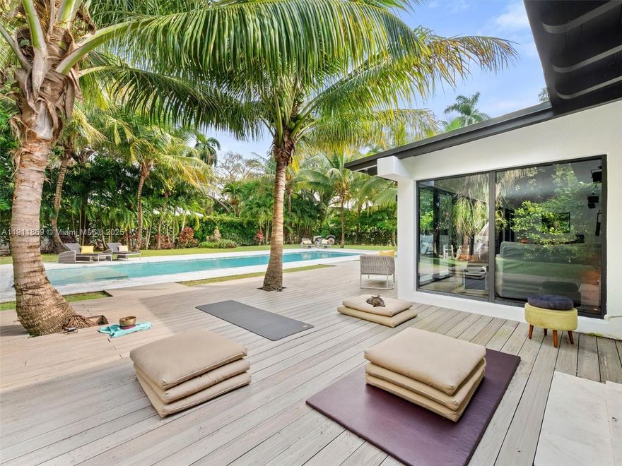 Enter this quiet, tropical retreat with the calming feel of Southeast Asia.  Fully Renovated in 2018 this 3 BD/3BA home sits on a 19,600 SF double lot with towering coco palms.  Inside, solid oak floors and marble baths ground the home with simple & beautiful materials.  The chef’s kitchen opens to a glass-lined living area with views of the  garden & pool. The modern home has impact doors & windows, a new roof, and sky lights.  A wide deck offers space for meditation or lounging. The tiki hut creates an easy outdoor living area, perfect for relaxing in the shade, reading, or dining. The large salt water pool completes the outdoor sanctuary. The entire setting feels blessed and transportive.  Located in El Portal, where streets are lined w mature shade trees and time moves a little slower.
