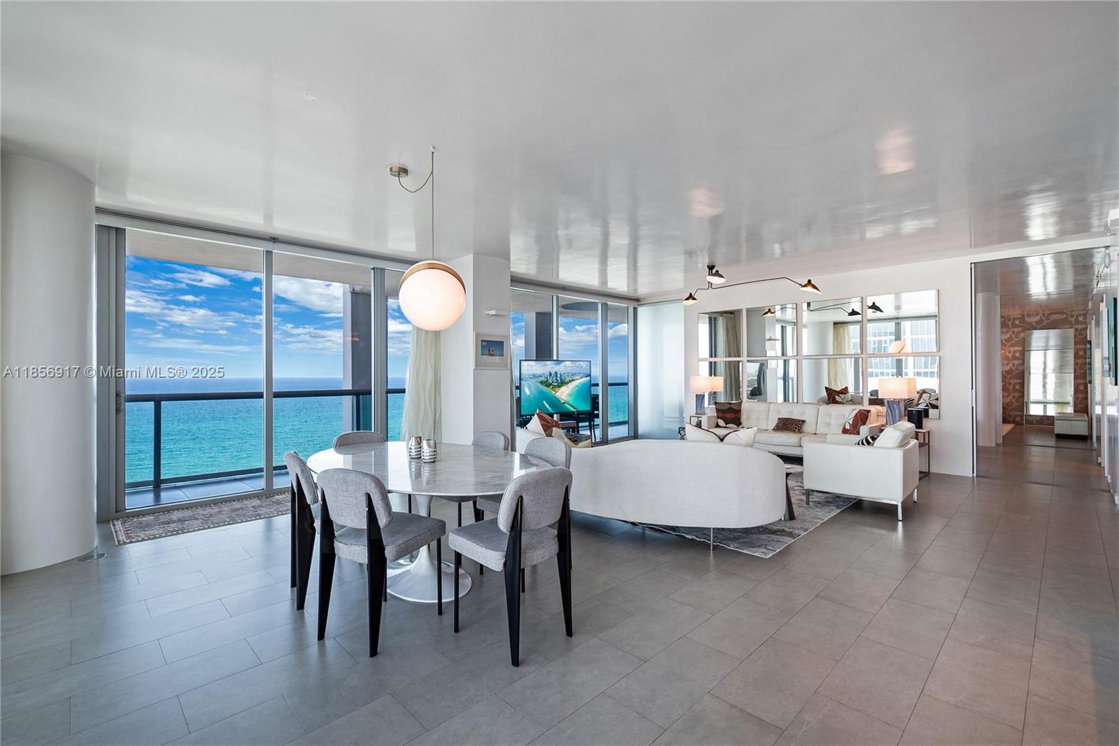From ocean sunrise to city sunset, experience Miami Beach at its finest in the only combined Lower Penthouse at Carillon Miami Beach. This one-of-a-kind sky estate spans 3,155 SF with a dramatic 1,040 SF terrace 52 ft long and 10 ft deep framing unobstructed 180° views. Interiors include a Bulthaup kitchen, Poliform closets, Cappadocia porcelain tile, Philippe Starck baths with Dornbracht fixtures, and Lutron smart lighting. Ownership offers two private parking spaces, valet, and 16 memberships to Carillon’s 60,000 SF spa & wellness center with oceanfront pools, thermal suites, curated programs, dining, concierge, and 750 ft of beachfront. A rare fusion of space, style, and wellness.