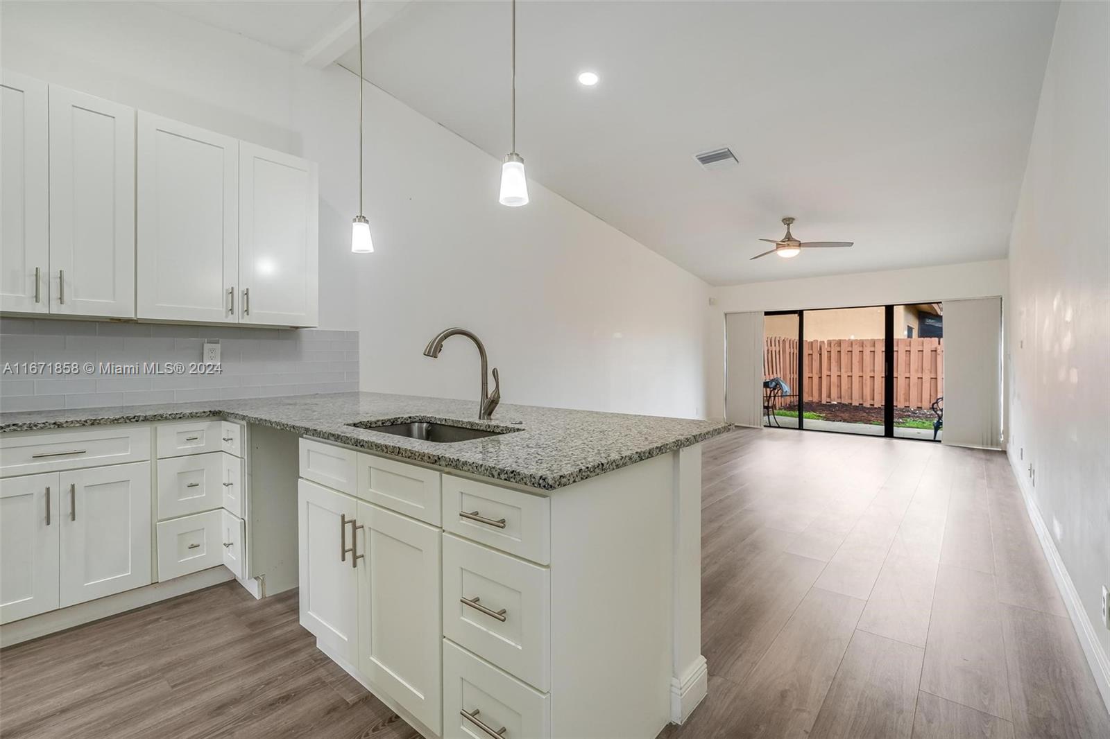 Welcome home to this beautifully villa in the heart of Plantation! This unit offers a combination of space & comfort. With an open layout, solid laminate waterproof floors, a fully renovated kitchen displaying 42” height wood wall cabinets, glass backsplash, granite countertops, soft-close drawer slides and a spacious pantry. Newer roof & rain gutters (Jul. 2023), 2.5 ton A/C with UV light and full duct replacement (Jan. 2021). Master bedroom updated in Mar. 2024 with an impact Vinyl sliding glass door with heavy reinforcement. The sliding glass doors lead out to a fenced courtyard across the lake with amazing views and lots of natural light! Conveniently located near Plantation Walk, parks, major shopping centers, hospital, dining, entertainment & more!