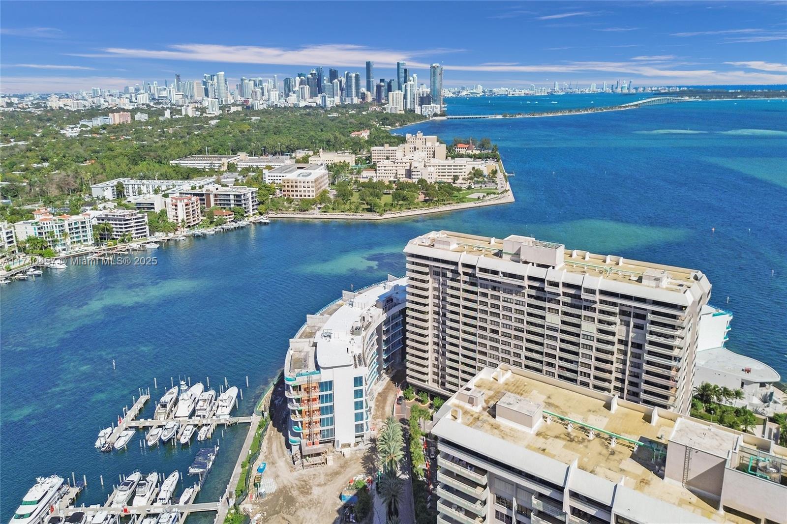 Back on the market! Exclusive island living in Coconut Grove. This spacious renovated condo features an enormous living area ideal for flexible entertainment, separate dining area and formal foyer. Desirable larger model with two bedroom/two bath split bedroom design with real engineered wood floors throughout and new a/c. Views from every room of Biscayne Bay, lush grounds with Coral Gables and Coconut Grove as your backdrop from the 187sf recessed balcony. Prestigious 20-acre private island w/resort amenities: gatehouse, pools, gym, walking paths, 24-hour security, garage, valet services, ultra elegant lobby and lush grounds. Serene oasis within minutes from vibrant Coconut Grove, Key Biscayne beaches, ultra trendy Brickell and Key Biscayne. No short term rentals.