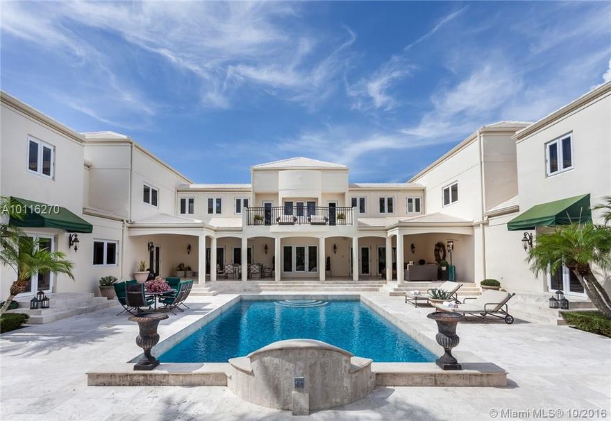 Located in esteemed Gables Estates, this extraordinary gated luxury home provides 181 ft. of expansive waterfront along with a 52 ft. dock. Design elements include a grand staircase, coffered and tray ceilings, crown moldings and travertine floors. Relax in the master suite with loft-style sitting room and spa-like bath. Home features indoor/outdoor spaces great for entertaining. All bedrooms contain en suite bathrooms and views overlooking the canal, sparkling pool, or beautifully landscaped garden.