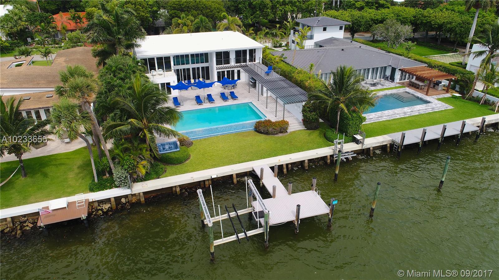 Enjoy living in this contemporary masterpiece completely remodeled in 2008, located on the wide open bay. 80+ Ft of water-frontage with panoramic views, private dock and 2 boat lifts. This 6 BR/5.5BA home is energy efficient, has a generator & 3-car garage. Take in stunning open bay views throughout this 5100sqft home. Modern design features custom stainless steel staircase, marble floors, floor-to-ceiling impact glass, infinity pool and summer kitchen.“Security Video/Audio Devices Operating on Premises.”