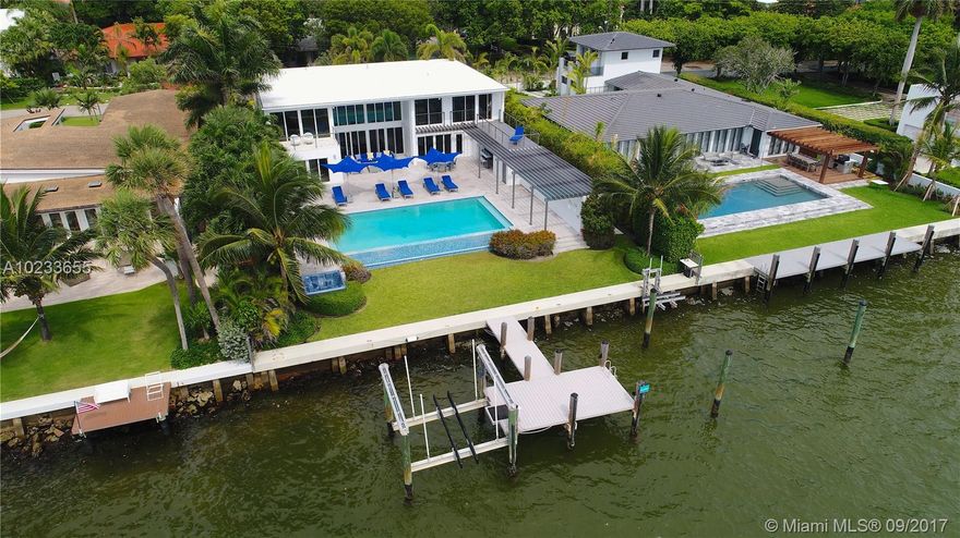 Enjoy living in this contemporary masterpiece completely remodeled in 2008, located on the wide open bay. 80+ Ft of water-frontage with panoramic views, private dock and 2 boat lifts. This 6 BR/5.5BA home is energy efficient, has a generator & 3-car garage. Take in stunning open bay views throughout this 5100sqft home. Modern design features custom stainless steel staircase, marble floors, floor-to-ceiling impact glass, infinity pool and summer kitchen.&#x201C;Security Video/Audio Devices Operating on Premises.&#x201D;