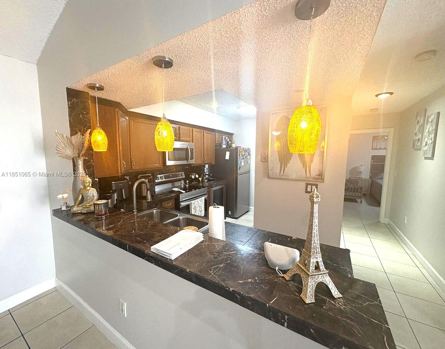 Seller motivated, $5000 towards closing costs!! Spacious and well-maintained 2-bedroom, 2-bathroom condominium, in-unit washer and dryer. The unit includes a utility closet on the balcony and boasts soaring vaulted ceilings, a generous kitchen with ample counter space, and a convenient in-kitchen dining area. The primary bedroom offers a large walk-in closet with attic access for additional storage, as well as a private balcony overlooking a tranquil garden area. This centrally located condominium is close to top-rated schools, major shopping centers, the 826 Expressway, and Florida’s Turnpike. The HOA allows immediate rentals: up to three times per year or annually. One assigned parking space is included; owners may register up to three vehicles. Ample visitor parking is also available.
