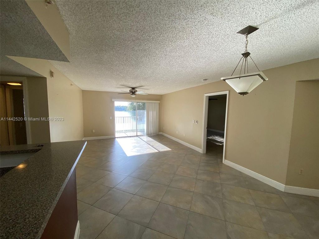 Photo of 5055 Wiles Rd #206, Coconut Creek, FL 33073 (MLS # A11442520)