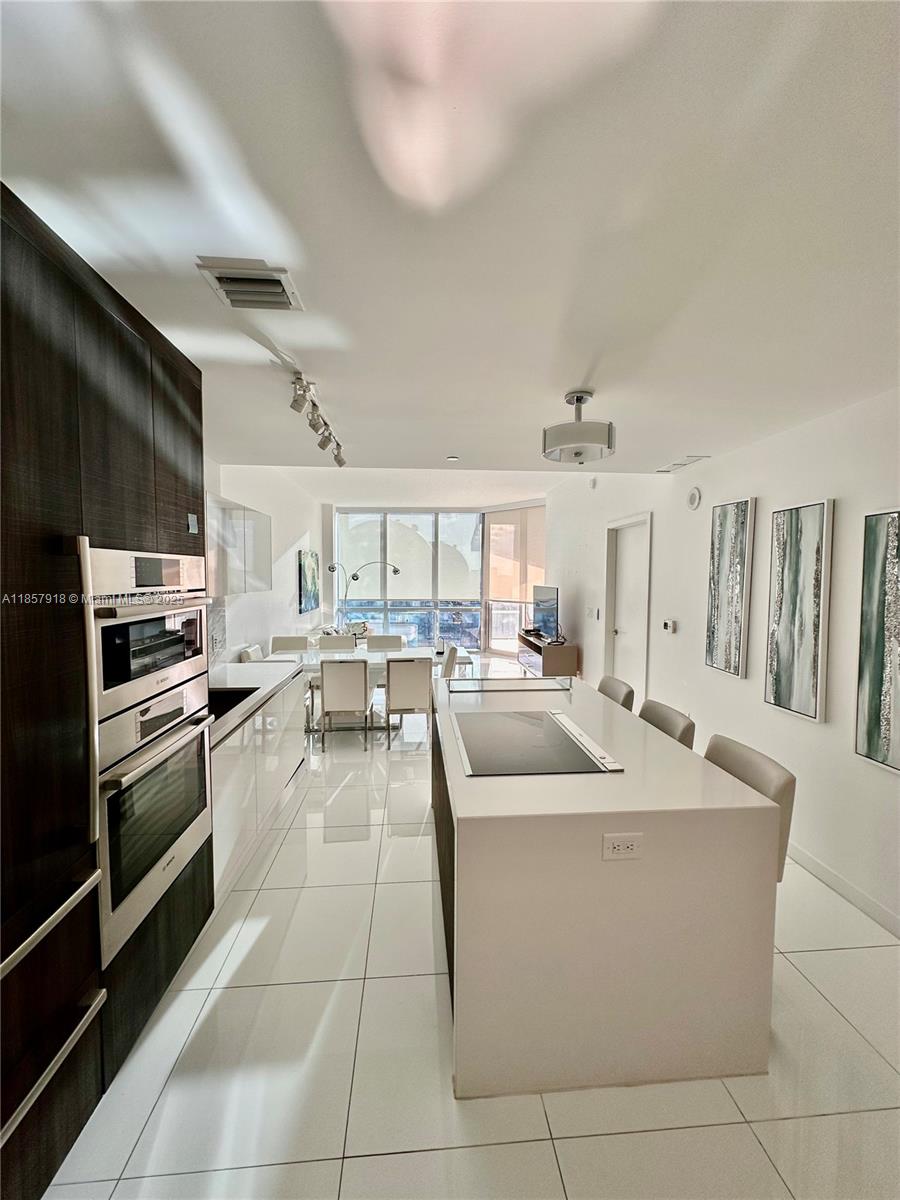 Marvelous oversized, 1 Bedroom + Den, 2 full Bathrooms condo completely furnished in the luxury building Paramount Miami World Center with the best amenities. Unit offers 10ft ceiling, private foyer, European Kitchen with breakfast bar, top of the line appliances, plenty of light with west views, Built-in closets, oversized balcony, blinds, washer and dryer inside the unit and much more. Rental includes internet, basic cable and water. Play your favorite sport, soccer field, tennis courts, basketball court, racketball, virtual golf, yoga studio, gym with boxing area, 5 pools, Spa, Kids playroom, Sky-deck..... Just amazing!