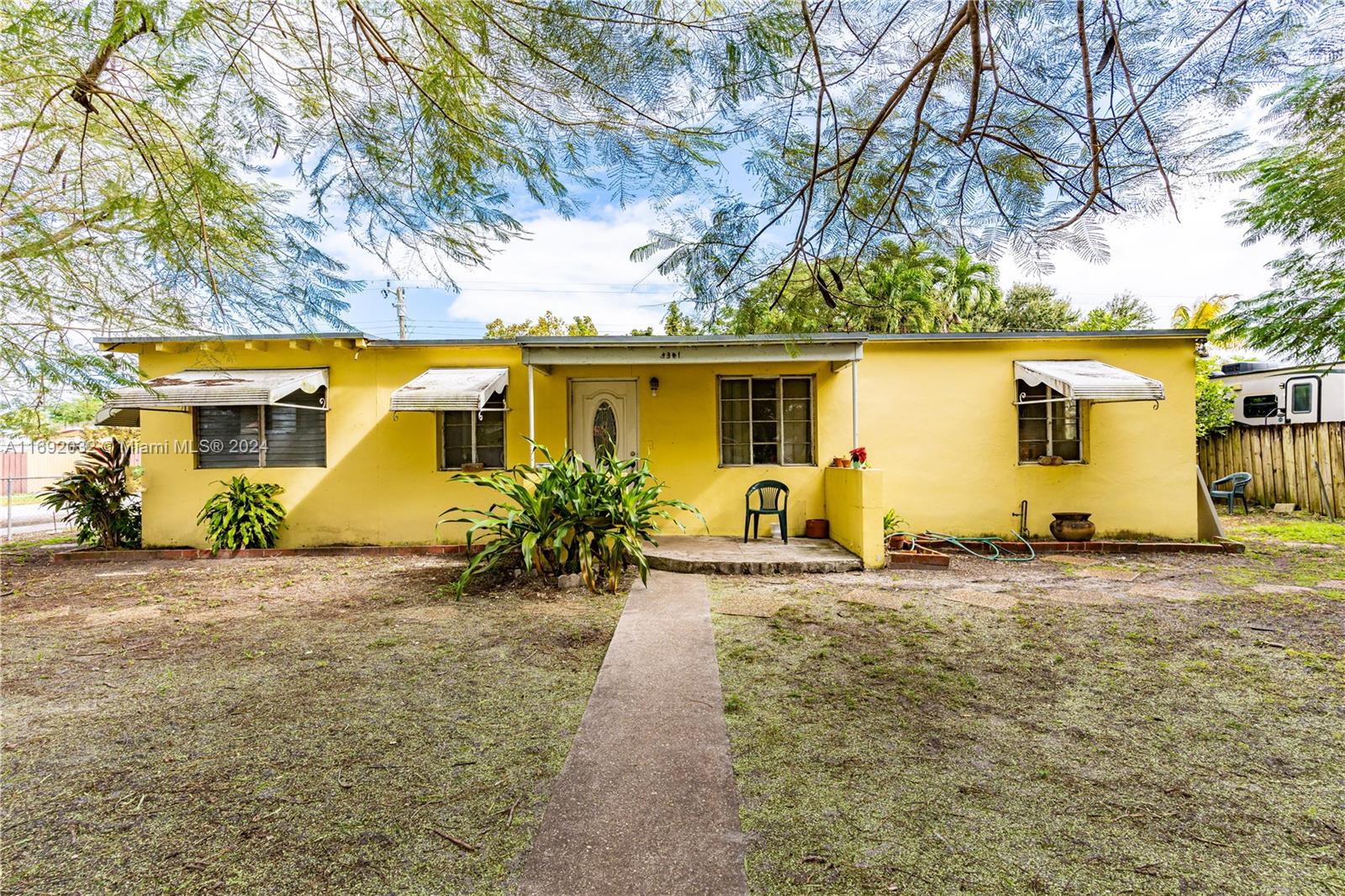 This fully fenced corner lot is centrally located just minutes from the FL Turnpike and the Palmetto. The property is being sold AS IS and requires TLC for the roof, bathroom, and kitchen. Cash offers are preferred; otherwise, a rehab loan will be needed due to water leaks in the roof that require repair. The buyer is responsible for paying the seller’s documentary stamps on the sale.