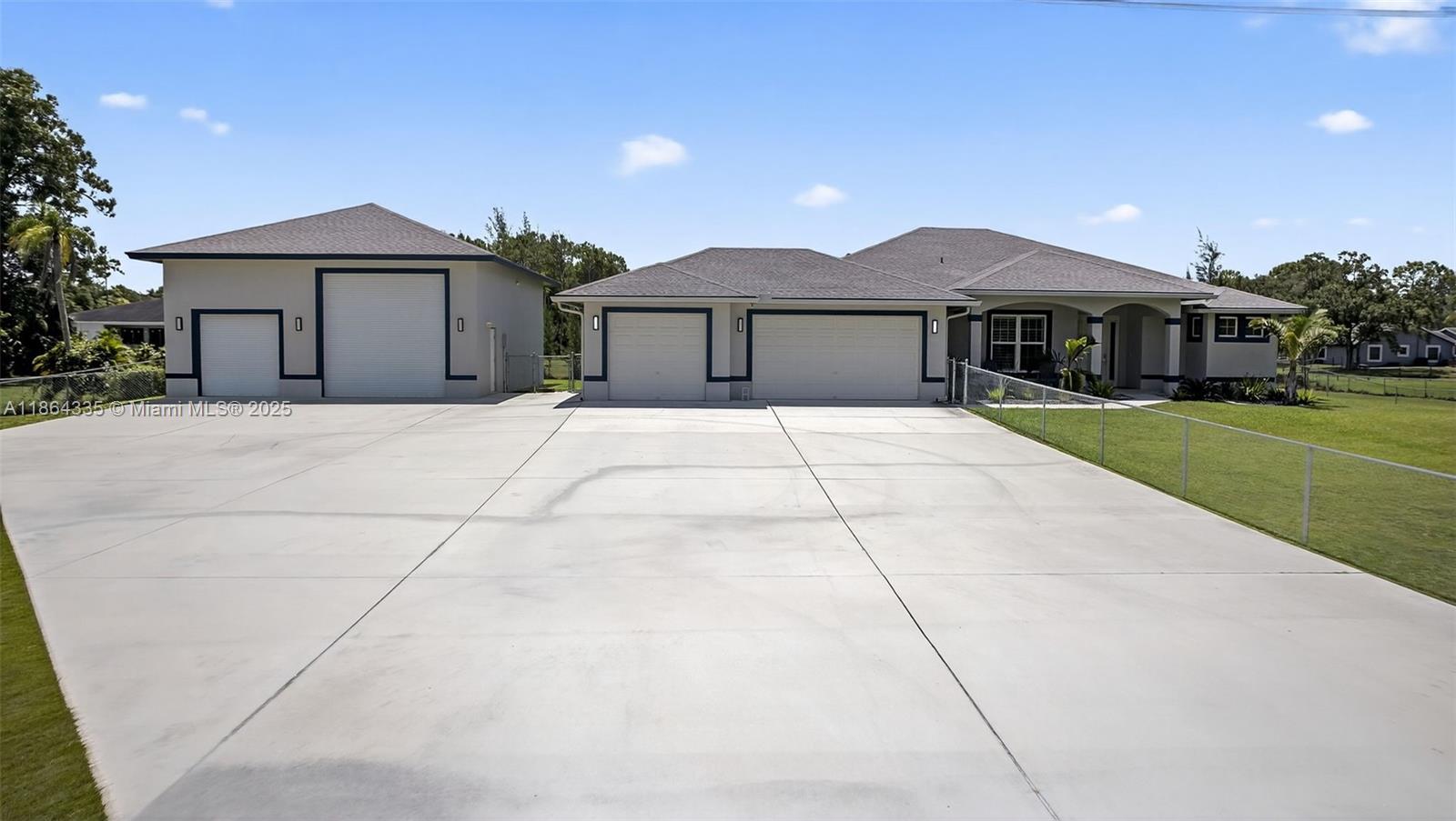 Room to roam on this private 1-acre estate in The Acreage. Built in 2018 with CBS construction, this custom home offers 3 bedrooms plus an office, 3 full baths, and a sophisticated open-concept design. The gourmet kitchen boasts GE Profile appliances, walk-in pantry, and sleek finishes. Porcelain tile flows throughout, complemented by custom built-in closets and a whole-house water filtration system. Designed with energy efficiency in mind, this Synergy-built residence combines comfort and style. A remarkable 1,200 sq. ft. drive-thru garage with loft provides endless possibilities for recreational vehicles, storage, or a private retreat—perfect for those who want it all.