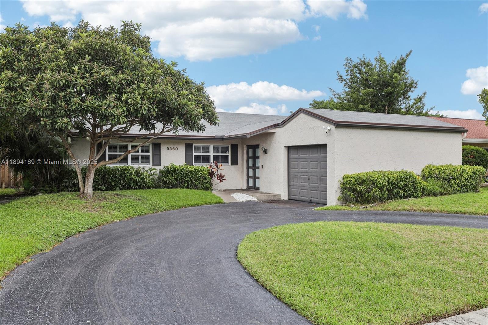 Experience this beautifully updated pool home in Welleby South, featuring a circular driveway and tropical curb appeal. Step into the foyer leading to a bright courtyard and an airy atrium filled with natural light from skylights in the new roof (under 1 year old). The open layout flows to a modern kitchen with custom white shaker cabinets, granite counters, farmhouse sink, smart refrigerator, and wine cooler. Tile floors throughout complement impact windows and doors with plantation shutters. Enjoy lush landscaping, a screened patio, oversized hot tub, and sparkling pool—perfect for relaxing or entertaining. Ideally located near Sawgrass Mills, Markham Park, I-595, I-75, and the Sawgrass Expressway, medical centers and schools.