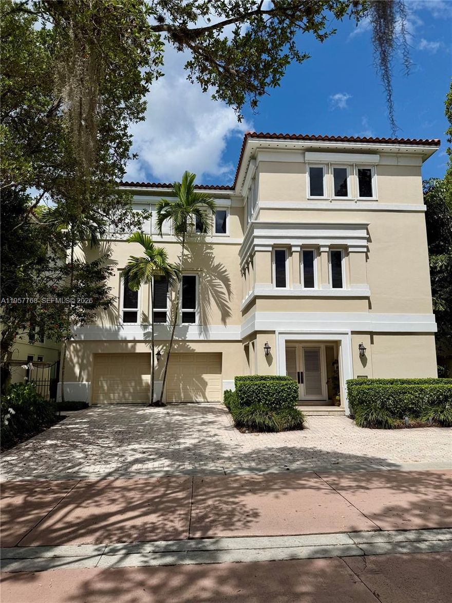 An exceptional opportunity to own one of only 25 single-family luxury villas in one of Coconut Grove’s most prestigious gated communities. This elegant residence, architecturally inspired by a timeless European villa, offers 4 bedrooms, 3.5 baths, and a private study. Interiors feature herringbone cherry wood floors, custom cabinetry, richly detailed millwork, and tray ceilings, blending classic sophistication with modern comfort. Expansive windows fill the home with natural light, while the lushly landscaped backyard provides a serene setting for outdoor living. Additional highlights include a private elevator and a rare 3-car garage. Bayshore Villas residents enjoy a private clubhouse, pool, tennis courts and marina, just minutes from Coconut Grove and Miami’s top schools. Furnishings available. 5,532 SF per appraisal.
