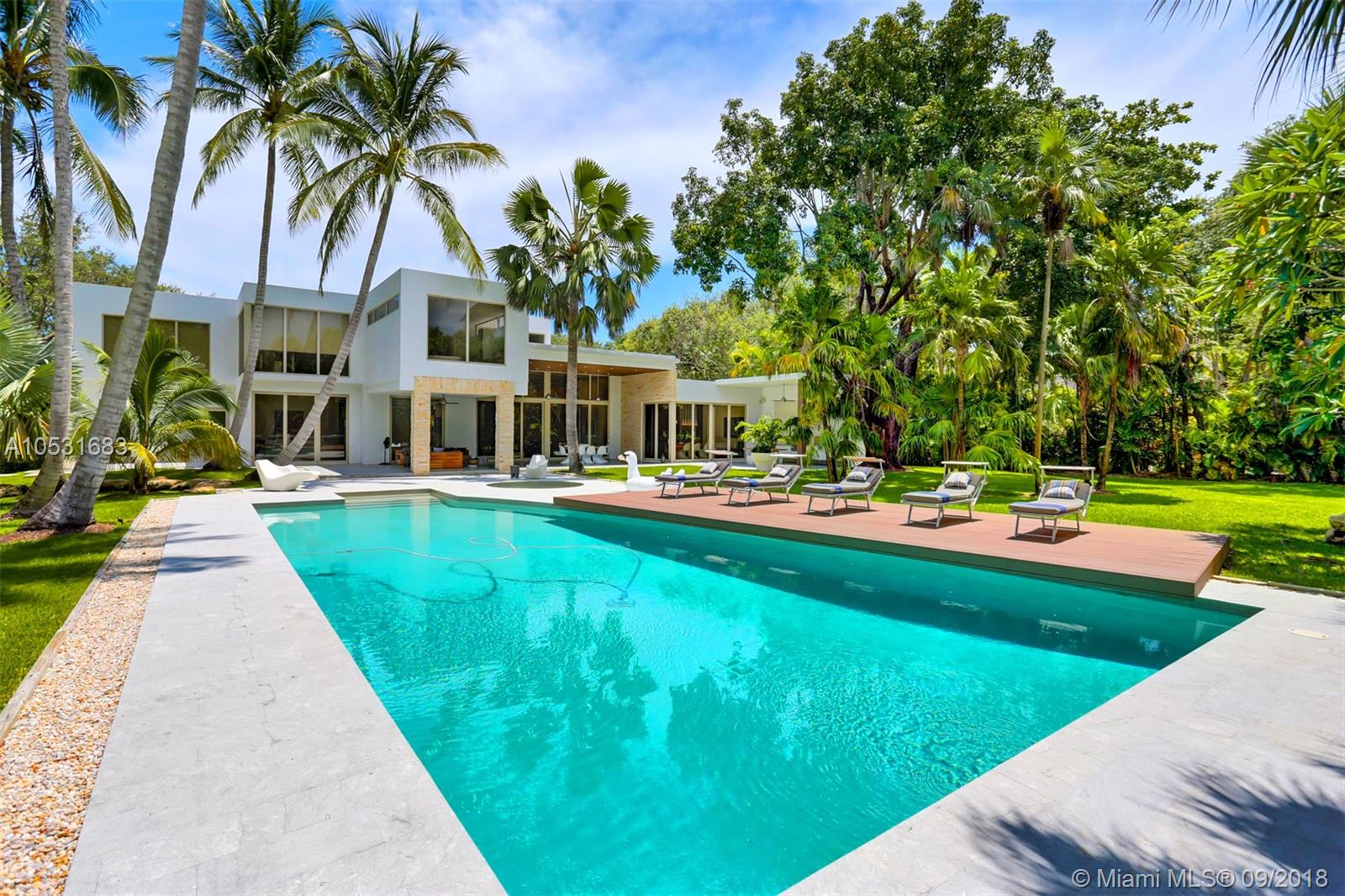 Rare combination of modern open-space living with warm colors and textures makes for this cool Family Loft. Fully geared up with all the technical features, spectacular tropical backyard , multiple covered terraces, an oversized pool/ hot tub and a wooden pool deck for great entertaining and vacation-like family moments. Great location in very charming neighborhood, close to best schools, parks, Marinas and an elegant country club. Highest standards include German kitchen & appliances, natural stone from Spain, Oak wood flooring, glass railings, Sonos sound system, TV surround system, generator, etc. Parking for 5 cars. Option for separate apartment. This house has got it all. Barely used feels like new construction and is move-in ready.