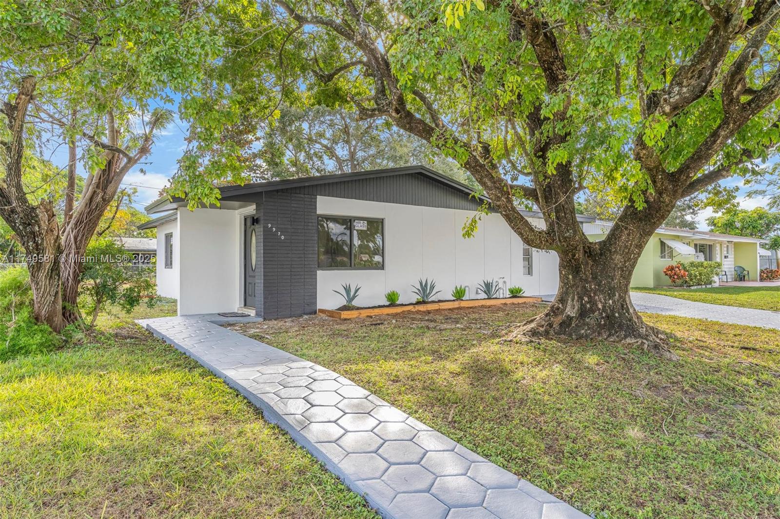 Floorplan allows for a potential efficiency/In-law quarter!!! Nestled in a premier family community, this beautifully remodeled 4-bedroom, 2-bathroom home offers modern living in a fantastic location near top-rated schools, dining, major highways, and the airport. The split floor plan, with entrances on both sides, provides unique flexibility to convert into two separate living areas or create the perfect space for entertaining. Featuring new luxury vinyl flooring, recessed lighting, a brand-new roof, impact windows, and tastefully remodeled bathrooms, this home is move-in ready. The expansive yard offers ample room for a boat, RV, or pool, ensuring privacy and space for all your needs.