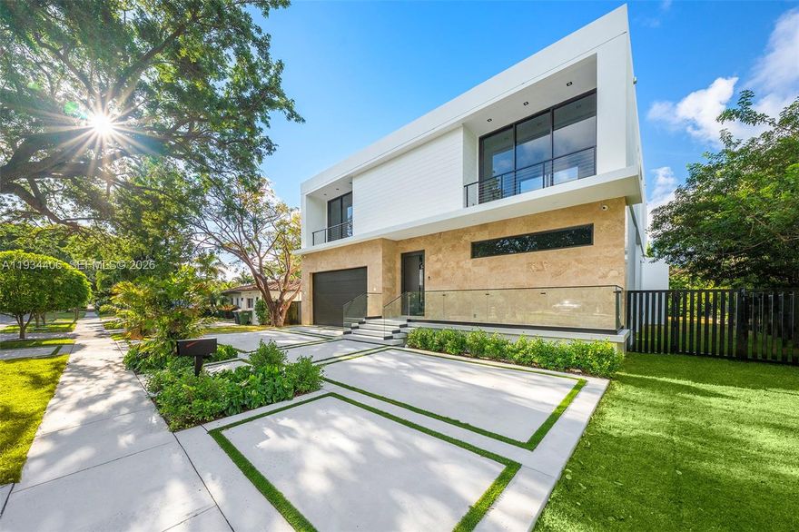 Architecturally refined single-family residence with completion scheduled for January 2026. Offering 4,300 SF of interior space, this thoughtfully designed home features 4 bedrooms, 5 bathrooms plus a powder room, service room, and an additional open flex-room with plumbing ready to convert into a full fifth bedroom with en suite bathroom. Designed in collaboration with an interior and yacht designer, the residence offers a highly functional floor plan with exceptional storage, clean modern lines, and beautifully curated natural light. The arrival experience is framed by a leather-finished travertine façade and a two-car garage. Seamless indoor–outdoor living connects the open layout to a summer kitchen, internal garden, pool, and sun-kissed south-facing outdoor area. A sculptural internal tree is intentionally showcased throughout the home, becoming a defining architectural focal point. The primary suite is a true retreat, featuring a spa-inspired bathroom with teak flooring in the shower and views toward a custom-designed private natural vertical garden wall, curated with plant selections chosen specifically for this space. High-end finishes, integrated systems, and generous storage complete this exceptional residence. Located in Keystone, a gated community just five minutes from Bal Harbour Shops and the beaches, this home offers privacy, convenience, and an elevated coastal lifestyle.