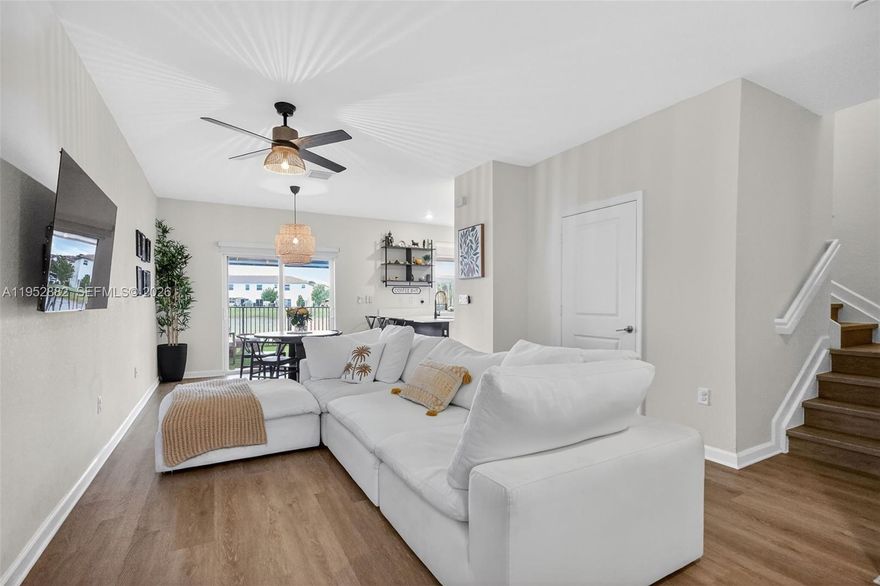 Welcome home to this beautiful turnkey townhouse built by Lennar in 2024 with amazing lake views.  This residence features 3 bed/2.5 baths/1 car garage and over 1,500 sq ft, a fenced backyard with artificial turf and decorative plants and rocks to enjoy breathtaking sunsets overlooking the lake, and a newly installed pergola with ceiling fan and lighting. Quartz countertops, modern backsplash and ss appliances in the kitchen.  The spacious primary ensuite with custom closets, and the primary bathroom upgraded with removal of builder-grade mirror and installation of two custom individual mirrors and double vanity, 2 additional bedrooms with high ceilings and custom closets, second bathroom with tub/shower combo, vinyl flooring throughout the home, updated light fixtures and ceiling fans, motorized garage door and overhead ceiling storage racks in the garage, 2024 AC and water heater, black out blinds, new washer and dryer, custom fixtures in the powder room, all impact windows and doors.  Entry covered porch area and 2 parking spaces in the driveway, plus additional across the street parking, that not many townhomes have. Westview offers residents amenities like a resort style pool, fitness center, kids play area, dog park, clubhouse, 24hr guarded entrance area. Located within minutes of Downtown Miami, Miami Beach, Miami Int' Airport, major highways, restaurants, shopping and more. Assumable mortgage of 4.2% offered.