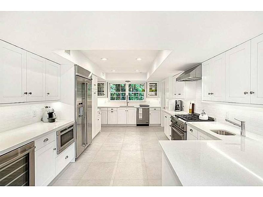 Live on prestigious La Gorce Island in this stunning, completely renovated colonial style home. Sitting on a 17,000SF Lot this beautiful 5,453SF 2 story home boasts 7BR/6+1BA, a gourmet kitchen w/ top of line appliances & finishes, fireplace, pool, restor ed wood floors, french doors, an expansive master suite w/ 4 walk-in closets & large ensuite bedrooms throughout. Enjoy contemporary yet classic finishes & ample natural light beaming through the family & living rooms overlooking the pool & lush garden.