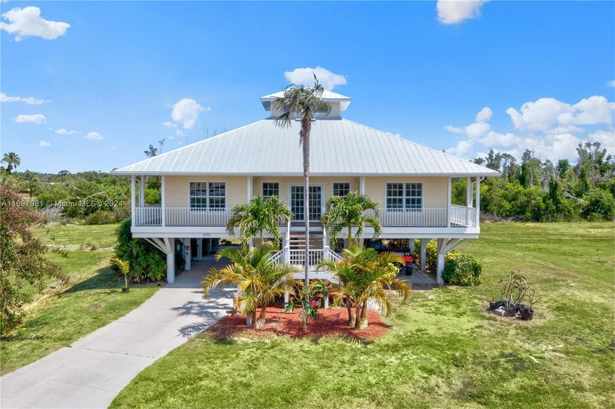 ABSOLUTELY NO FLOOD DAMAGE! Key West style home on expansive private land. Luxurious 4-bedroom, 3-bathroom home on 5 acres of prime land with the option to purchase an additional 5 acres, all zoned AG-2. This elevated, two-story home features a wrap-around deck and a screened porch, offering the perfect blend of indoor-outdoor living. It features modern amenities such as an elevator, two A/C units, impact windows and a new roof. The lower level is the perfect space for a mother-in-law suite, including a private bedroom, bathroom and additional space. This prime location offers easy access to Pineland Marina and short boat rides to popular destinations like Cabbage Key, Cayo Costa, Sanibel, and Captiva. Schedule a tour today to discover the perfect blend of luxury and tranquility.