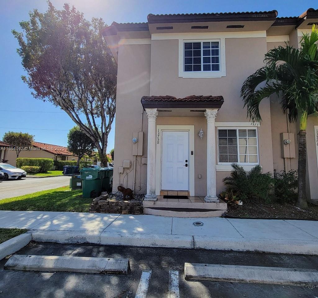 This charming, 2 Bedrooms, 2 1/2 bathrooms corner-unit townhouse offers both privacy and curb appeal in a quiet and children-friendly neighborhood, Cazadores South. It boasts a light beige exterior accented by elegant white trim and topped with brown Spanish tile roofing. New, beautiful hurricane-proof windows and doors installed, while the corner lot placement means fewer shared walls and more outdoor space. Situated on a tree-lined street with two parking lots and easy access to nearby shops, schools, and parks, this home blends style, convenience, and comfort—ready for its next owner to move in and make it their own.
It has a paved and roofed terrace, with some plants giving it a green touch which, together with the mounted outdoor TV, you can enjoy while having a BBQ in the afternoon.