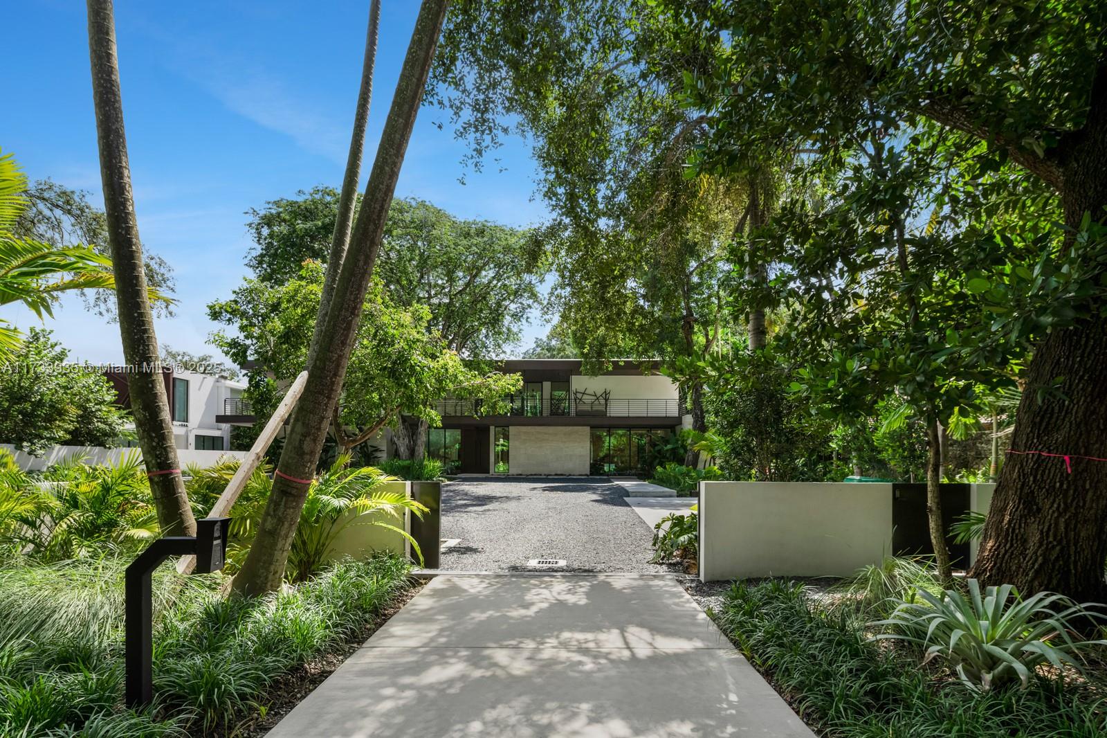 Elevate your expectations in this stunning contemporary masterpiece in the heart of Coconut Grove. With its soaring ceilings and light-filled interiors, every room offers a sense of spaciousness and elegance. The seamless flow from the indoors to the expansive outdoor living area creates an entertainer’s dream—complete with a covered summer kitchen and a tropical heated pool and spa, surrounded by the lush greenery of nature’s finest backdrop.
This home is not just a place to live, it’s a lifestyle. Featuring a private guest house, a fully equipped gym, a movie theater, and an outdoor kitchen cabana, you have everything you need to entertain in style. Experience the perfect blend of luxury, comfort, and nature in this one-of-a-kind Coconut Grove residence. Welcome to your dream home.