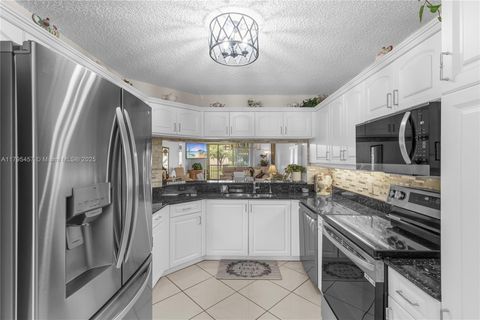 Photo of 2541 N Nob Hill Rd #205, Sunrise, FL 33322 (MLS # A11795457)